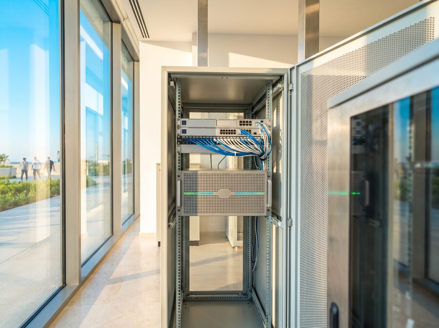 A rack-mounted GPU server in a bright back-office comms cabinet